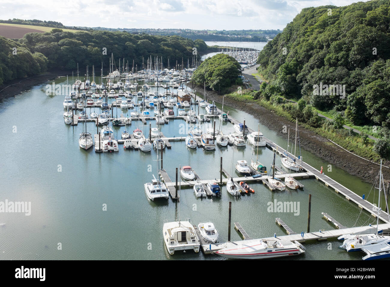 Boats moored on pontoon on River Cleddau at Neyland, Milford Haven Stock Photo