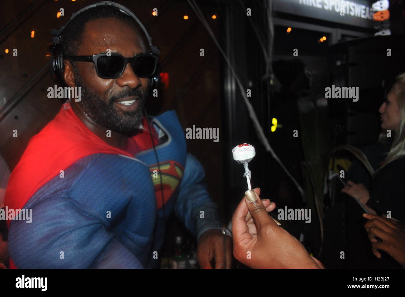 Idris Elba performing a DJ set at the Box Park being handed halloween candy Stock Photo