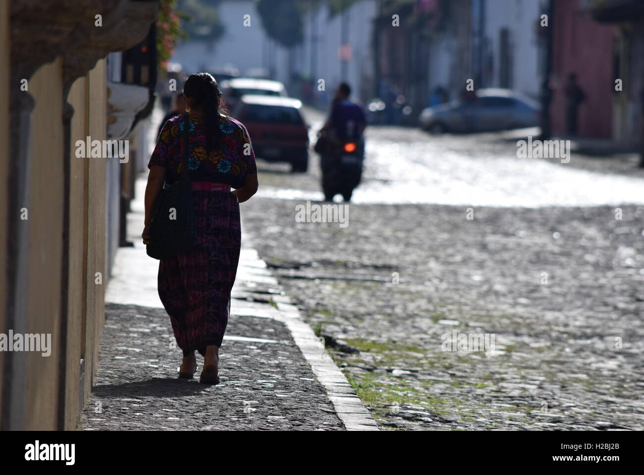 Indigenous woman walking on the street in Antigua, Guatemala Stock Photo