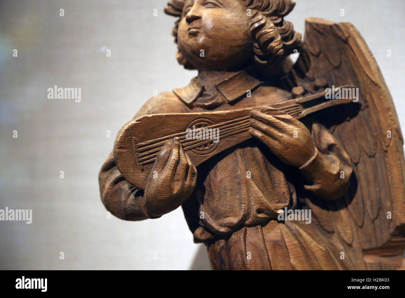 Musical angel playing  a gittern (ancestral to the modern guitar). Wood. French. Carved about 1450-1500. Stock Photo