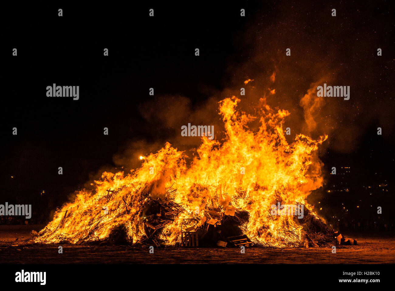 People celebrate St John's Eve (Sant Joan) around a bonfire in a beach of Estartit, Costa Brava, Catalonia, Spain. Stock Photo