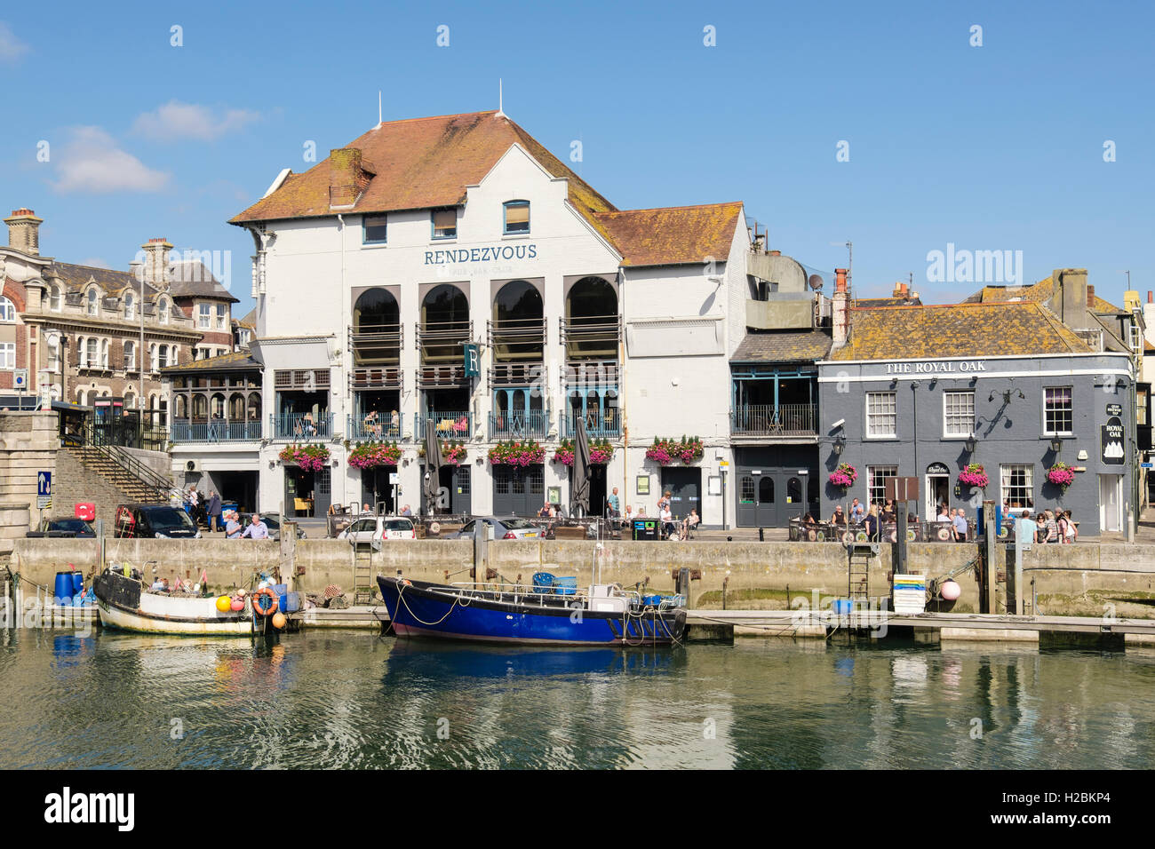 View across harbour on River Wey to waterfront restaurant and Royal Oak pub. Custom House Quay, Melcombe Regis, Weymouth, Dorset, England, UK Stock Photo