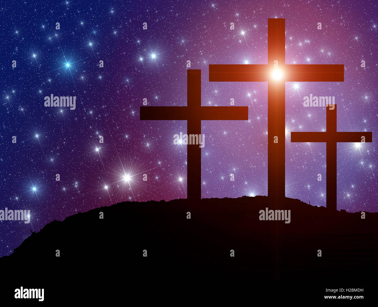 Jesus' cross on the Calvary hill with sky filled by twinkling sparkling stars as a  symbol of Christianity end Easter concept. Stock Photo