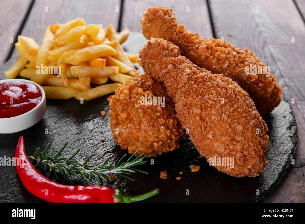 Breaded crispy chicken leg fried french fries sauce Stock Photo