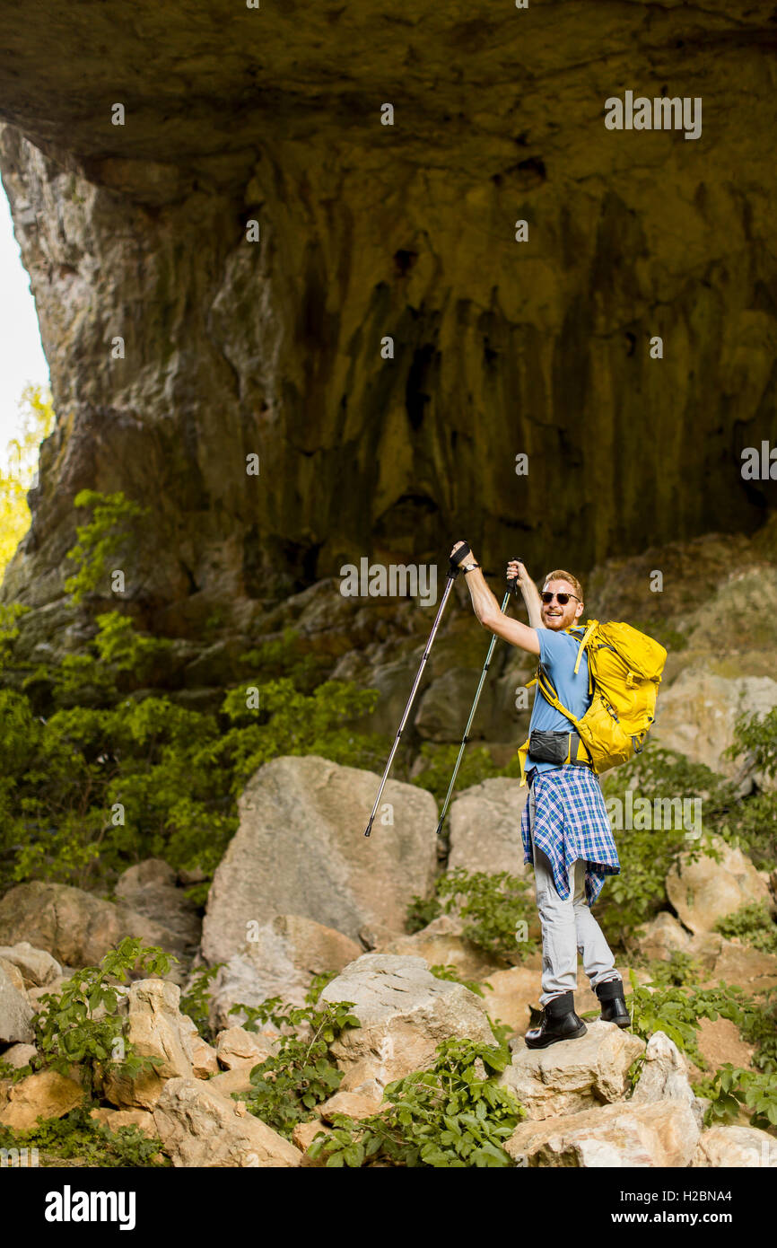 Caucasian male model with backpack hiking on sunny day Stock Photo - Alamy