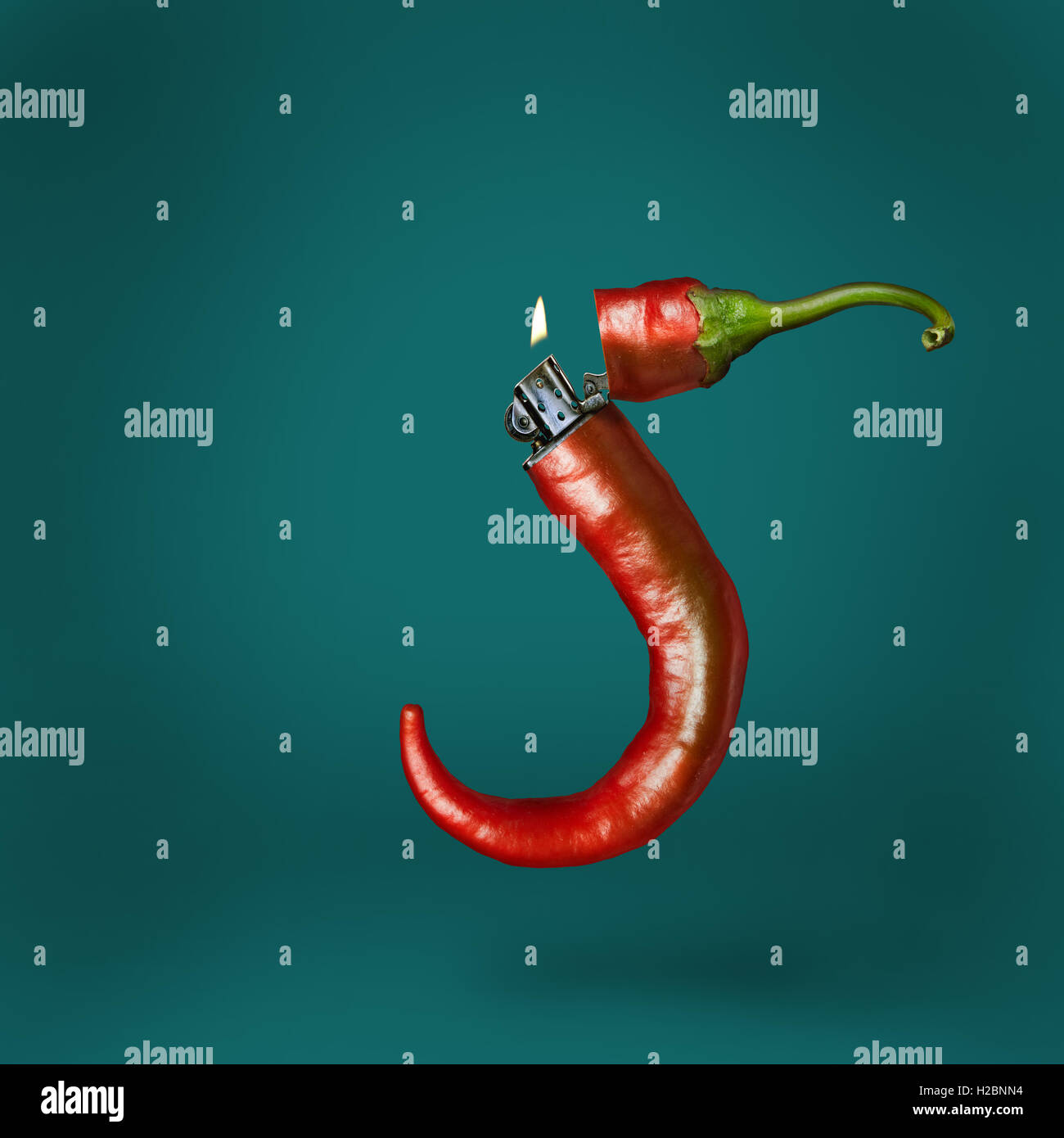 Lighter chili pepper on a green background Stock Photo Alamy