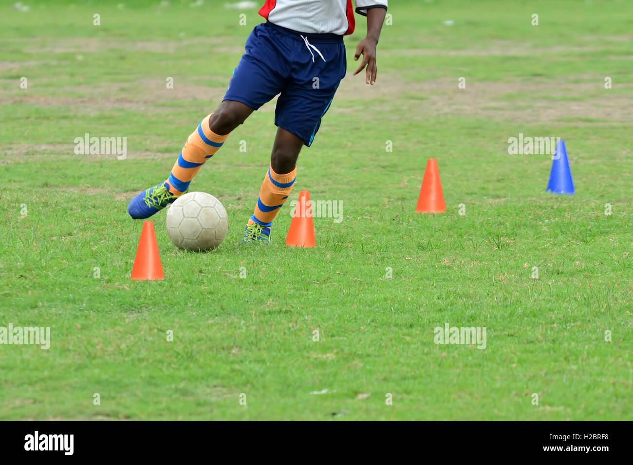 Soccer players practicing dribbling Stock Photo - Alamy