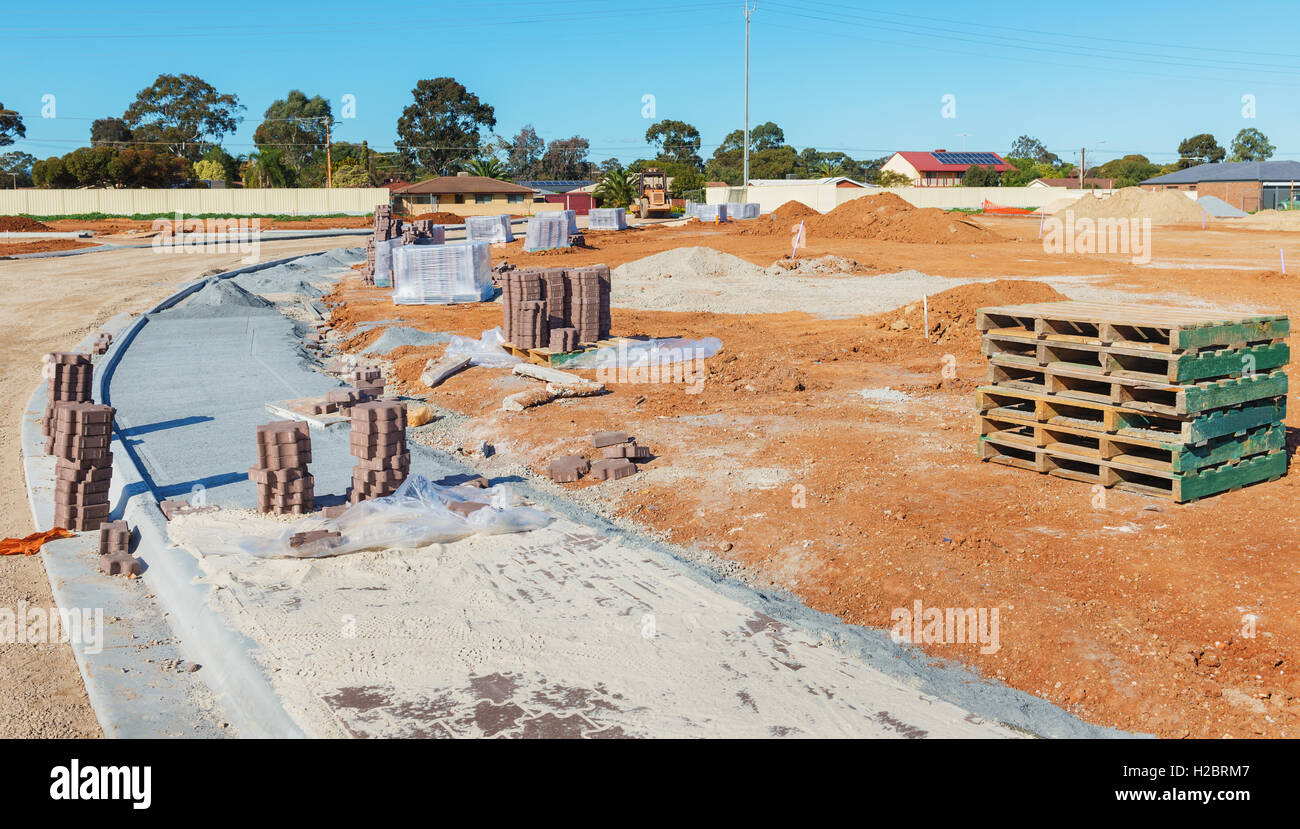 new sidewalk during construction and new plots for homes construction Stock Photo