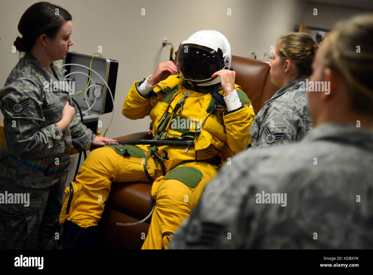 A U.S. Air Force U-2 pilot tests the sun visor on his helmet as he is assisted into his high-altitude full pressure suit before a flight at the Beale Air Force Base January 8, 2013 in Maryville, California. Stock Photo