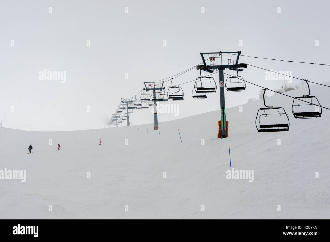 Chairlifts at Faraya or Mzaar Kfardebian Ski resort during a snowy day, Lebanon, winter in the Middle East Stock Photo