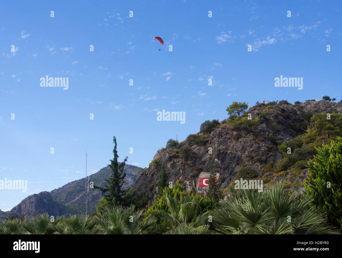 Tourist playing paragliding guided by a pilot Stock Photo