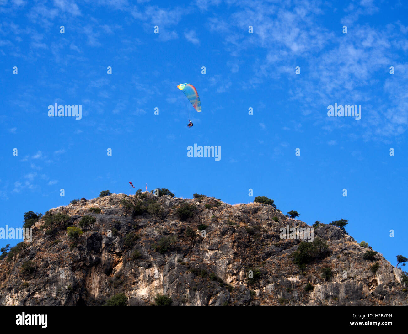 Tourist playing paragliding guided by a pilot Stock Photo