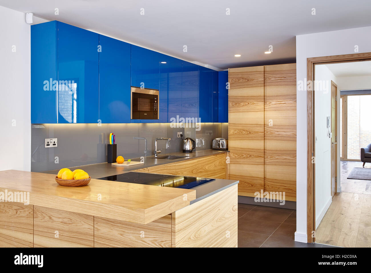 Kitchen area with blue cupboards and fruit. Peel Place, London, United Kingdom. Architect: Dexter Moren Associates, 2016. Stock Photo