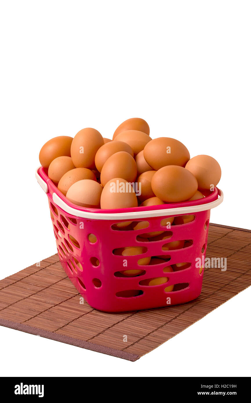 chicken eggs in a basket on a white background Stock Photo