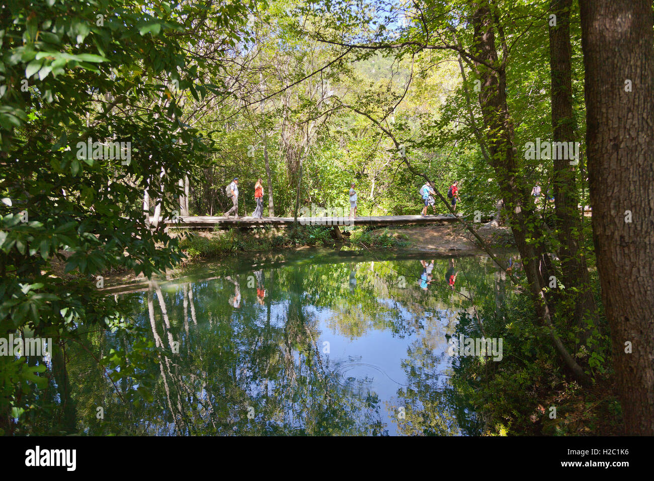 Krka National Park, Croatia, wooden path walkway with tourists, water reflections Stock Photo