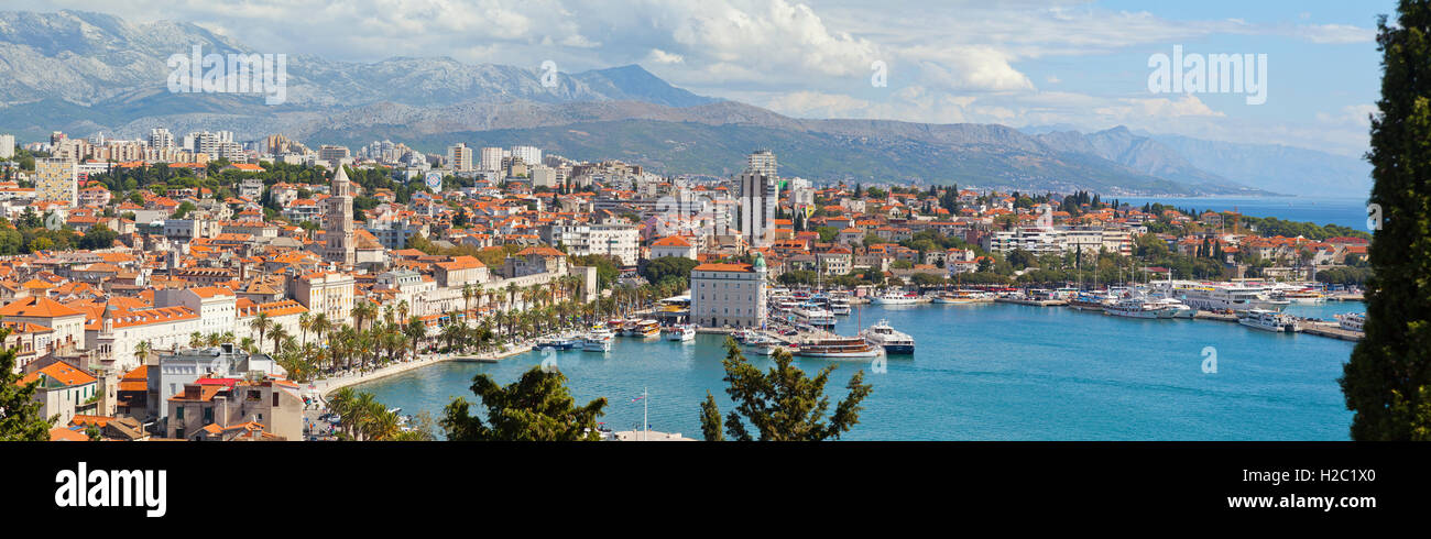 Panoramic view of Split town, Croatia. Viewed from the West. Bright sun. Mosor mountain range in the background. Stock Photo