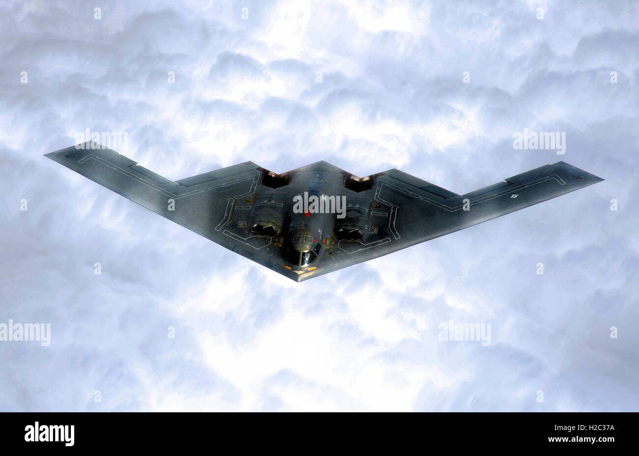 A U.S. Air Force B-2 Spirit stealth strategic bomber flies over the clouds after taking off from the Whiteman Air Force Base October 30, 2002 in Johnson County, Missouri. Stock Photo