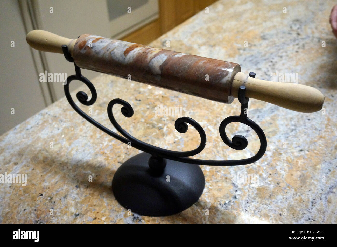 Decorative Marble Rolling Pin displayed on a Wrought Iron Stand Stock