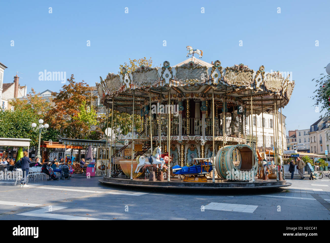 Old fashioned carousel on the main square of Fontainebleau, France. Stock Photo