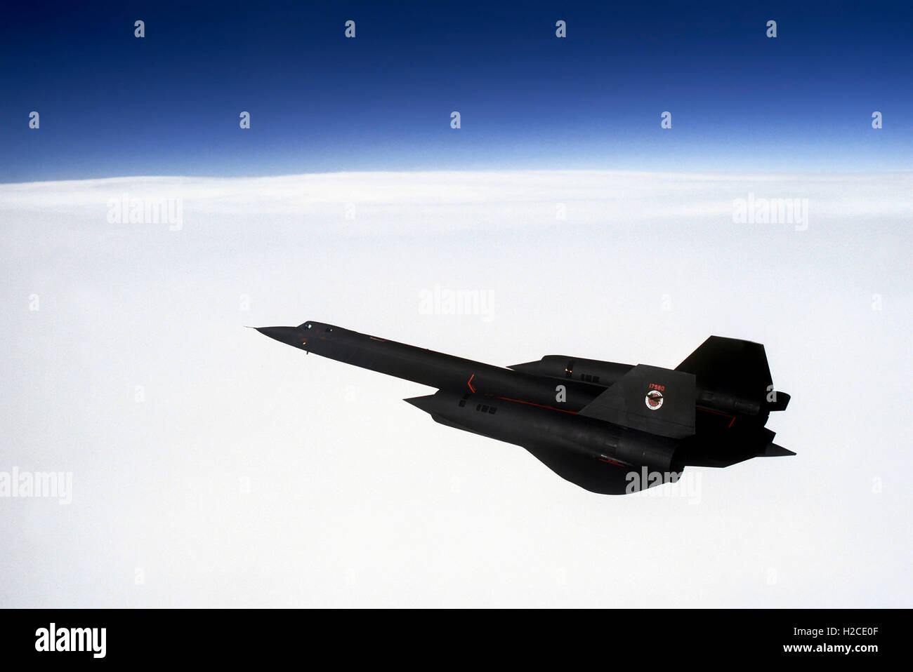 A US Air Force SR-71 Blackbird long-range strategic reconnaissance aircraft flying at high altitude during a mission out of Beale Air Force Base. The Blackbird can travel at 2,100 mph at 80,000 feet and is capable of surveying 100,000 square miles of Earth’s surface per hour. Stock Photo