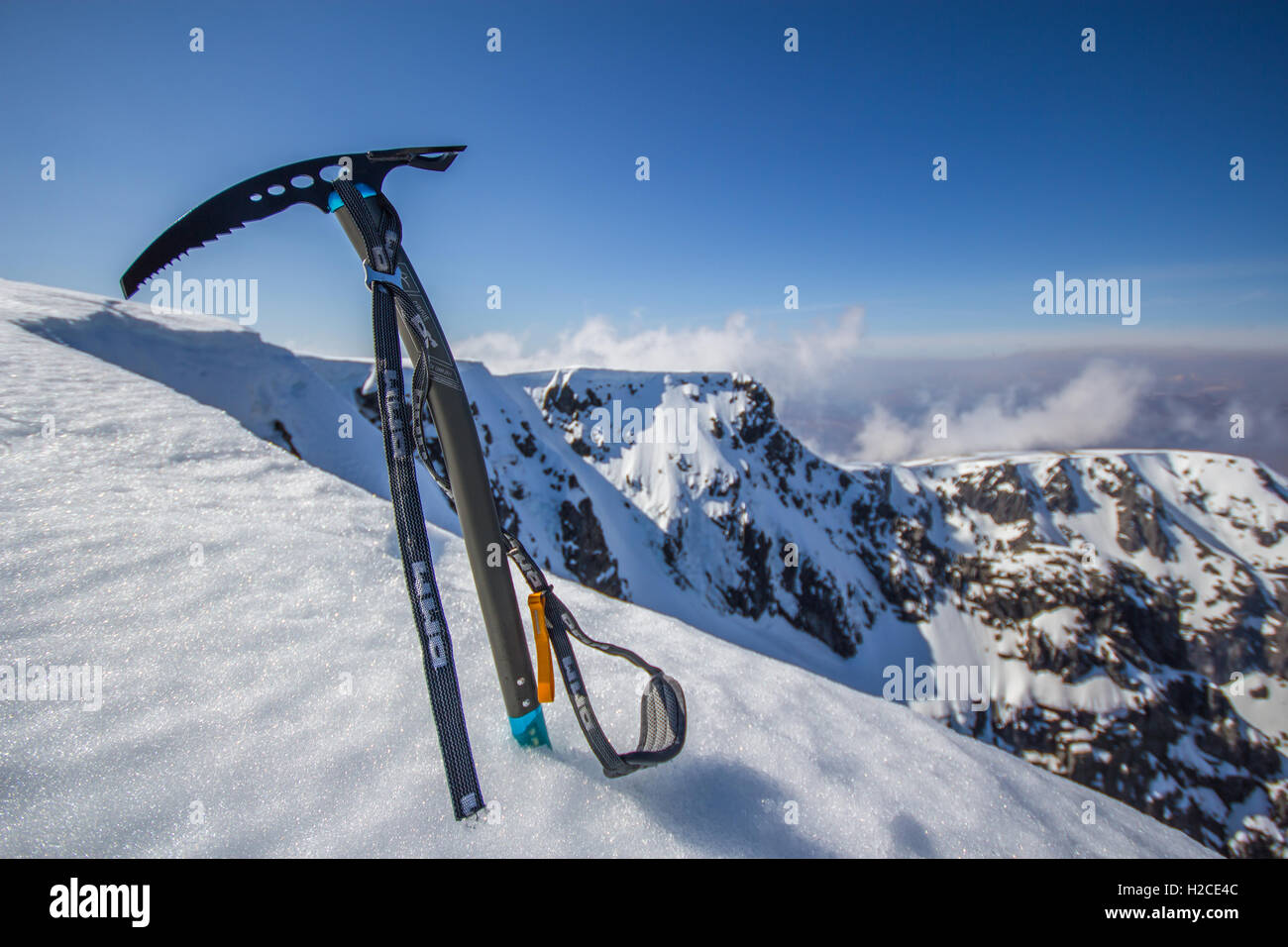 Ice axe stuck on the summit of Ben Nevis in winter after climbing the north face Stock Photo