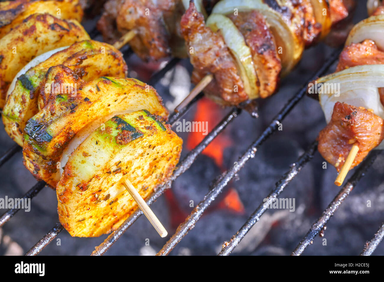 Close up picture of a zucchini and meat skewers, garden barbecue, selective focus. Stock Photo
