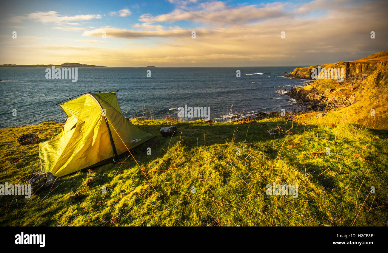 Tent  on the island of Eigg just off the cliff at sunset Stock Photo