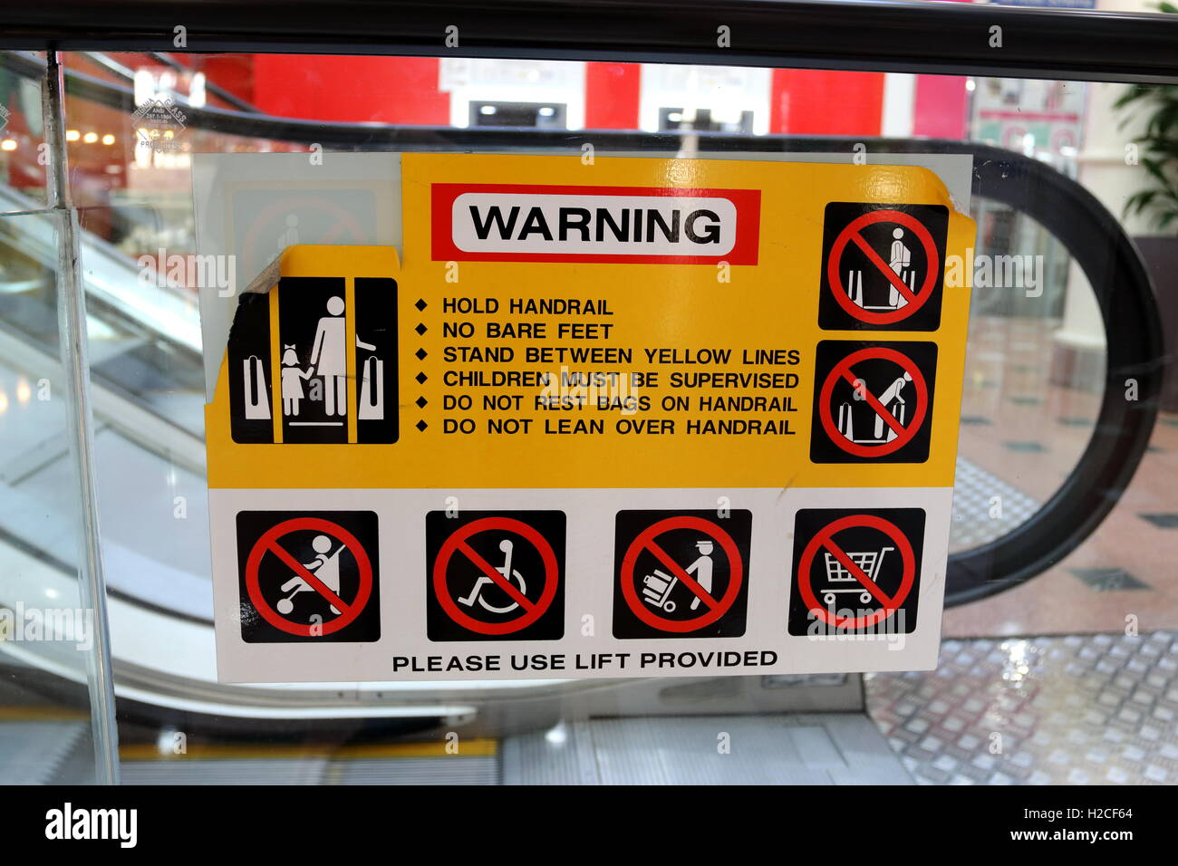 Escalator warning in shopping mall in Melbourne Victoria Australia Stock Photo