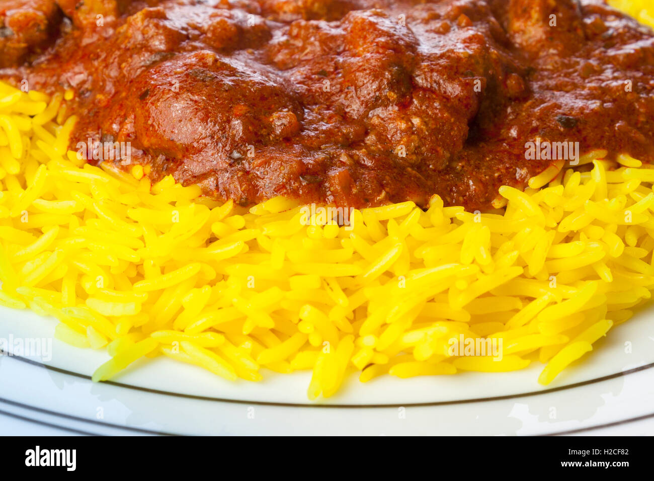 Close up of a plate of lamb jalfrezi curry and pilau rice Stock Photo