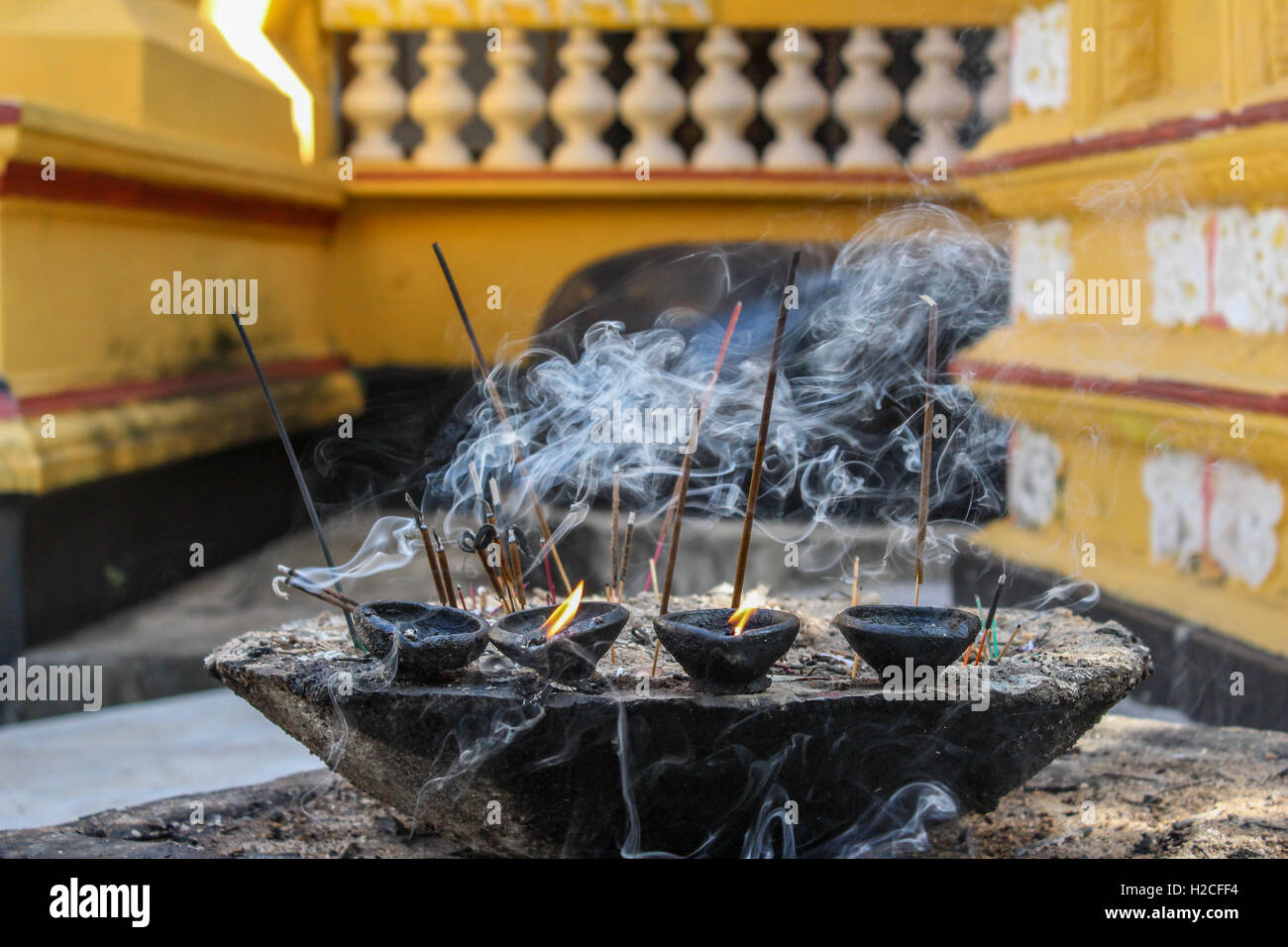 Incense Burning and Oil Lamps Spirituality at Buddhist Temple Stock Photo
