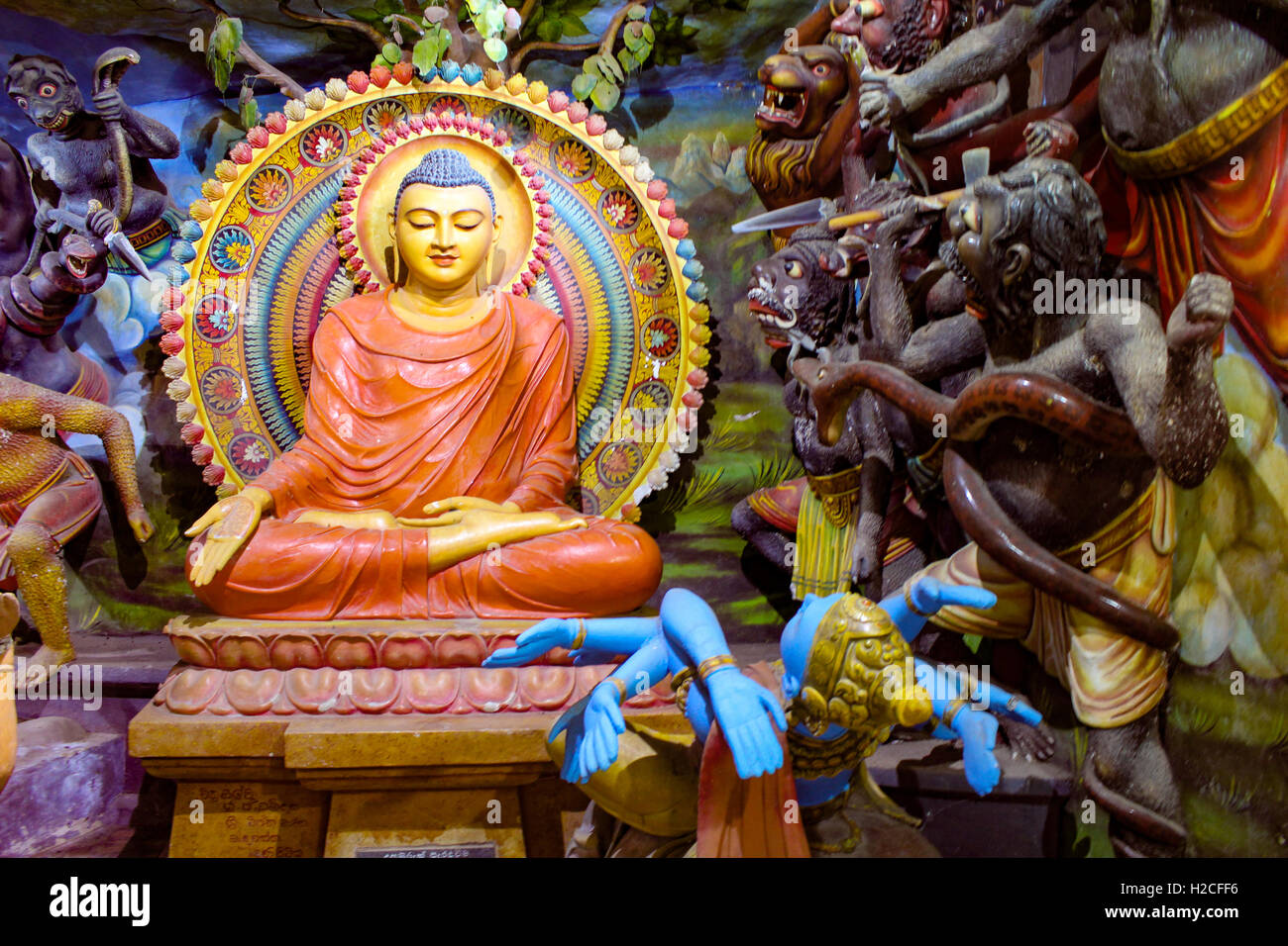 Buddhist depiction of Buddha showing compassion and calm against evil Stock Photo