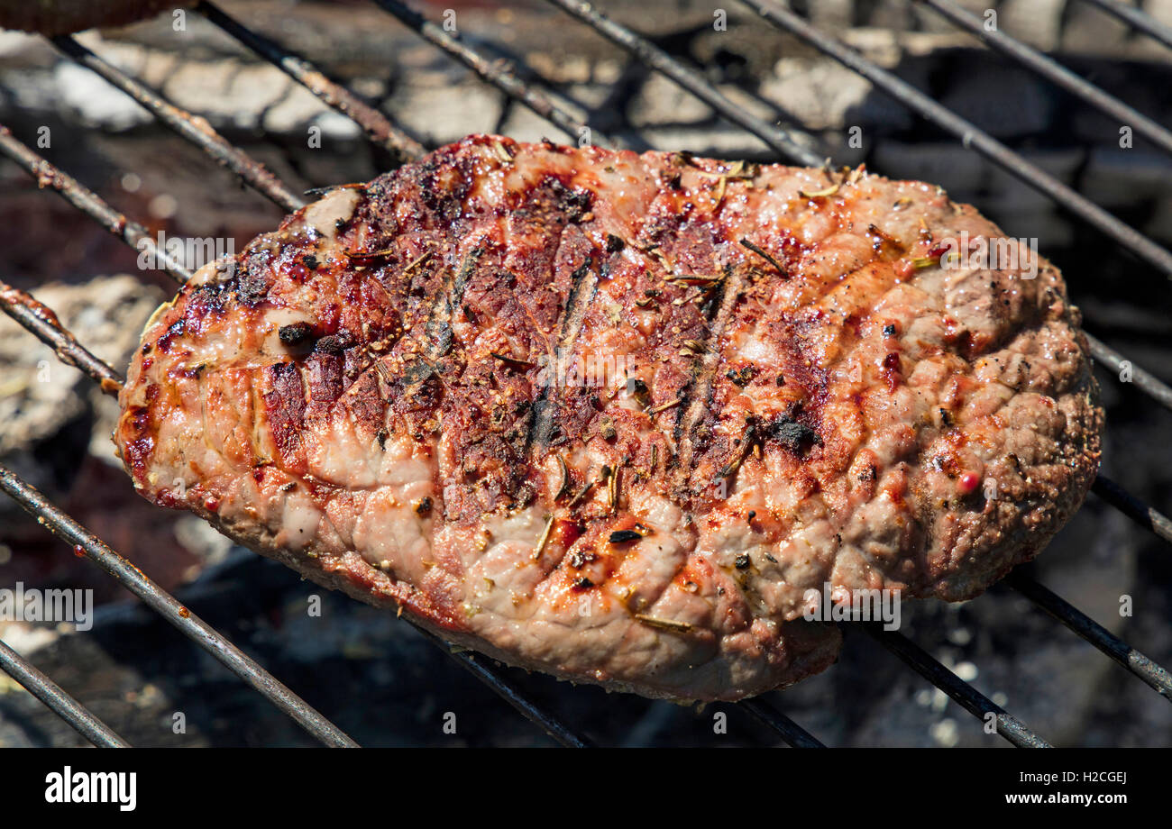One grilled beef steak barbecue cooking prepared on bbq grill, close up ...