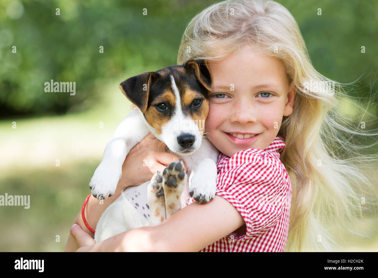 Portrait Of Girl Holding Pet Dog Stock Photo