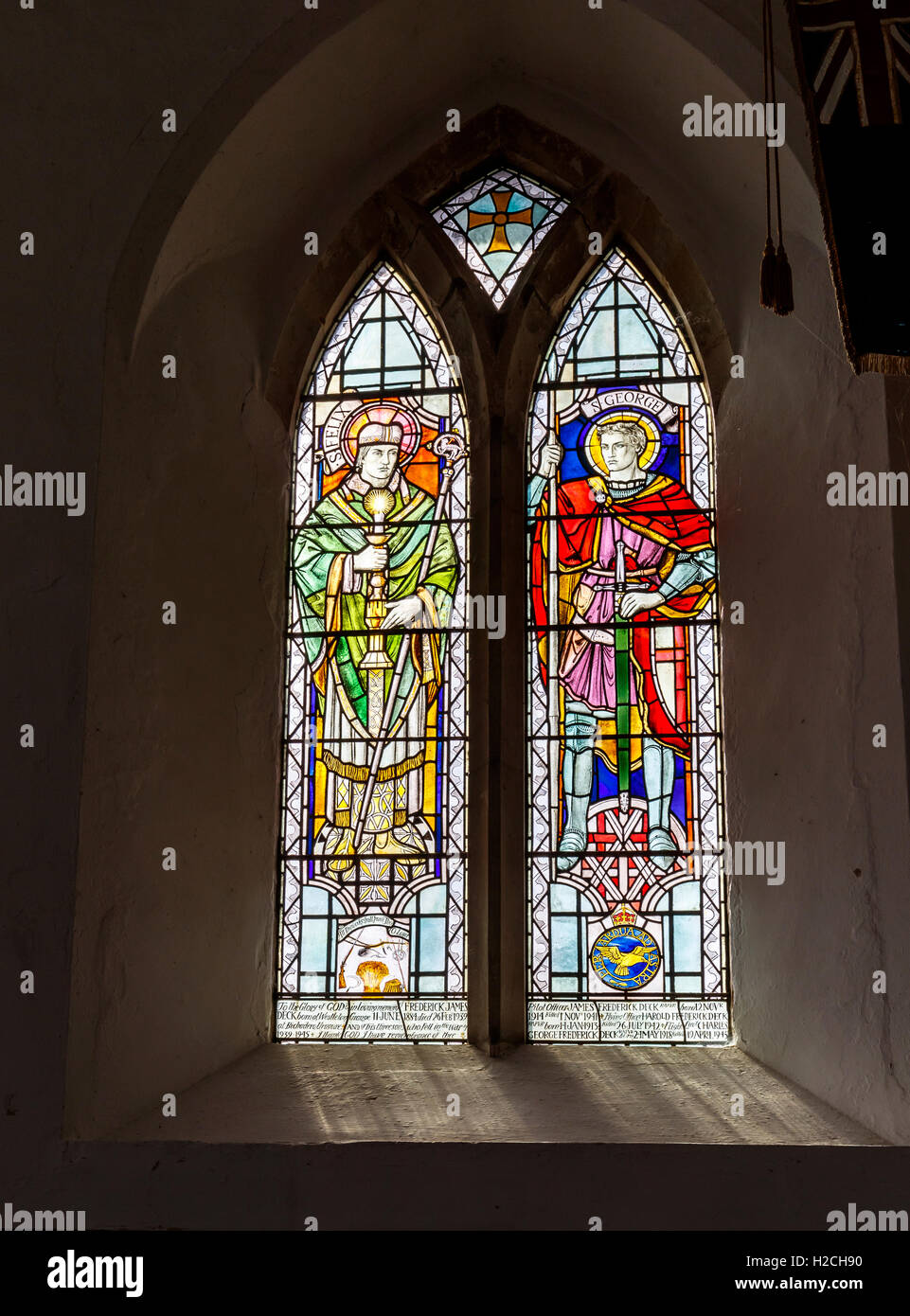 Stained glass window dedicated to the dead of two world wars in St Peter's Westleton, a 14th century thatched church in Suffolk Stock Photo