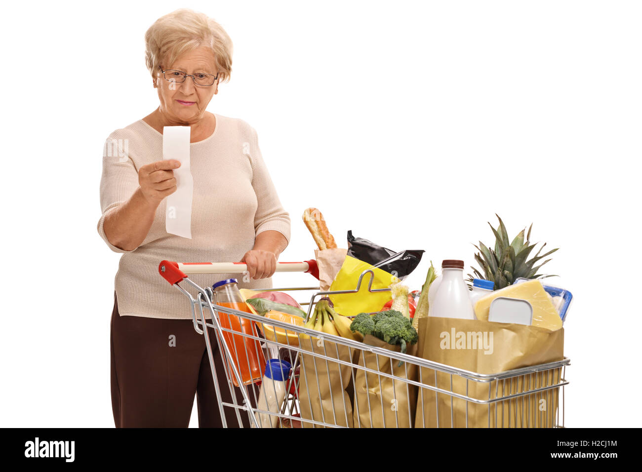 Mature woman looking at a store receipt isolated on white background Stock Photo