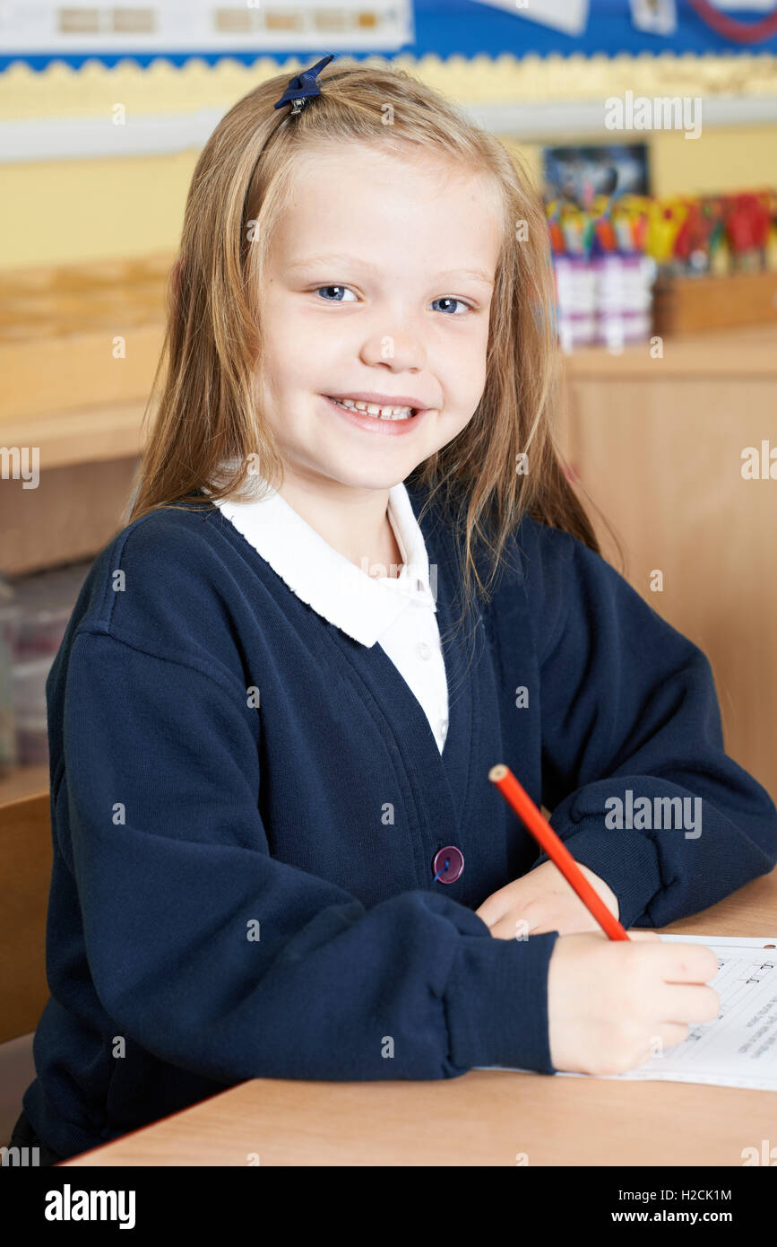 Female Elementary School Pupil Working At Desk Stock Photo - Alamy