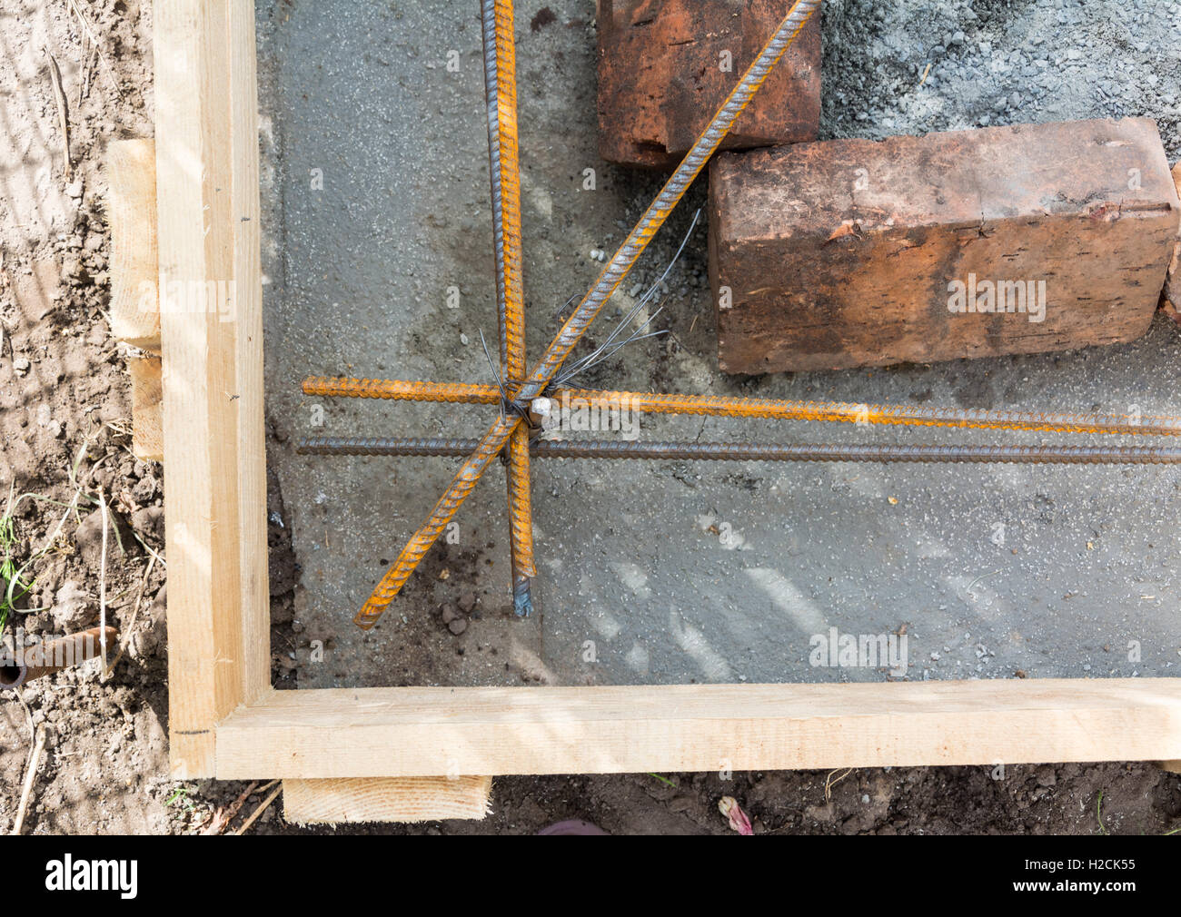 Pouring the concrete foundation by hand Stock Photo