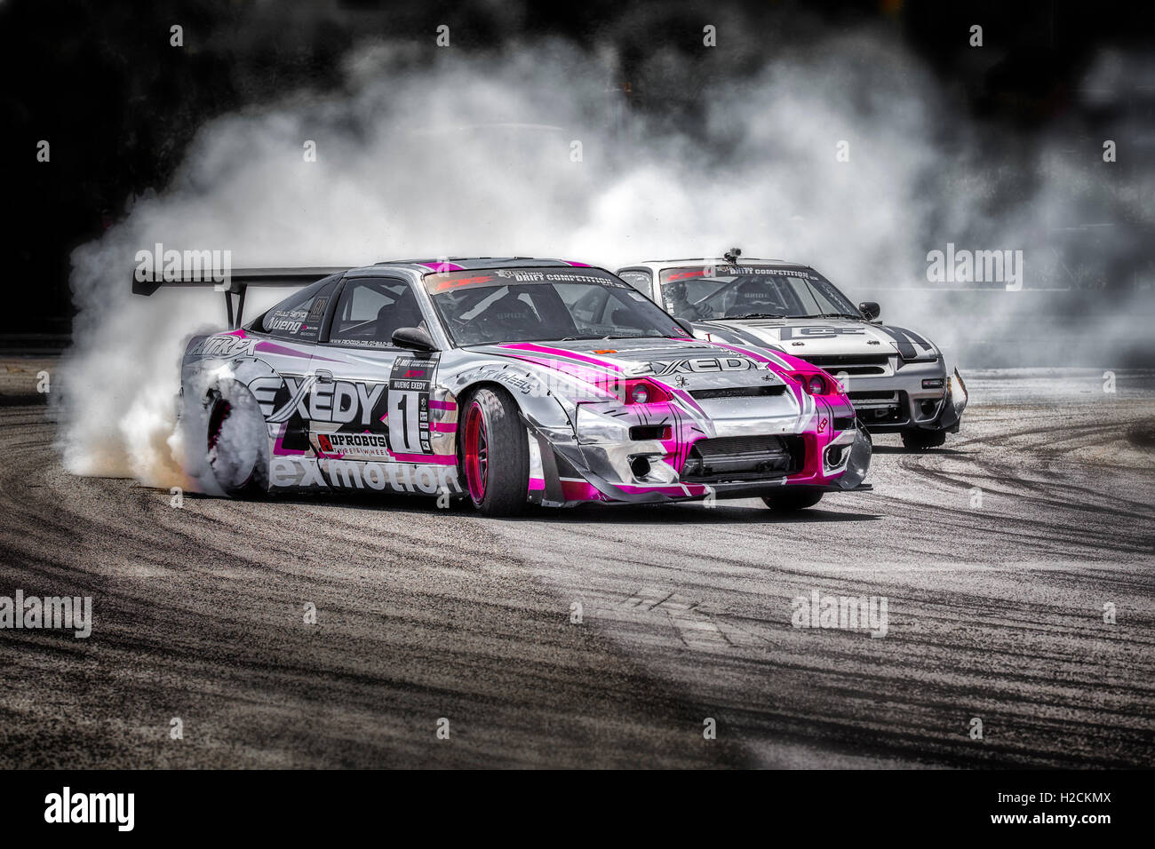 Car drifting auto racing event action with smoking tyres. Pattaya Stock  Photo - Alamy