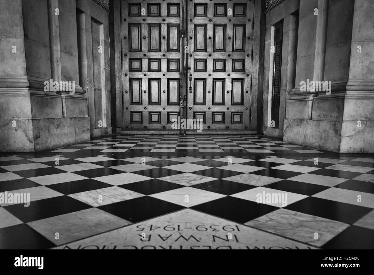 Wooden doors of St. Paul's Cathedral and square floor tiles in London. Stock Photo
