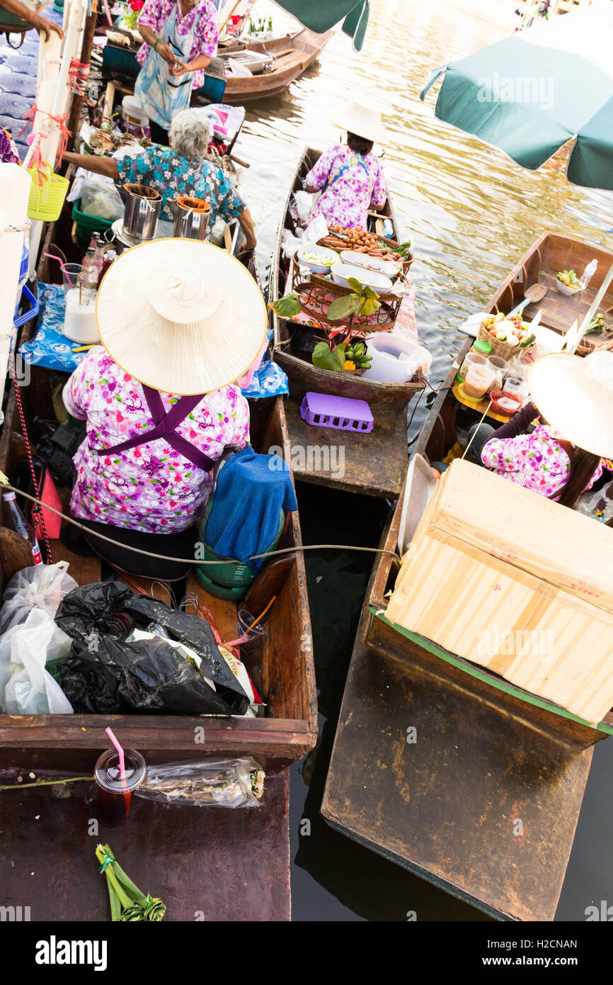 Woman vendor are carrying foods for sell through floating market on the canel Stock Photo