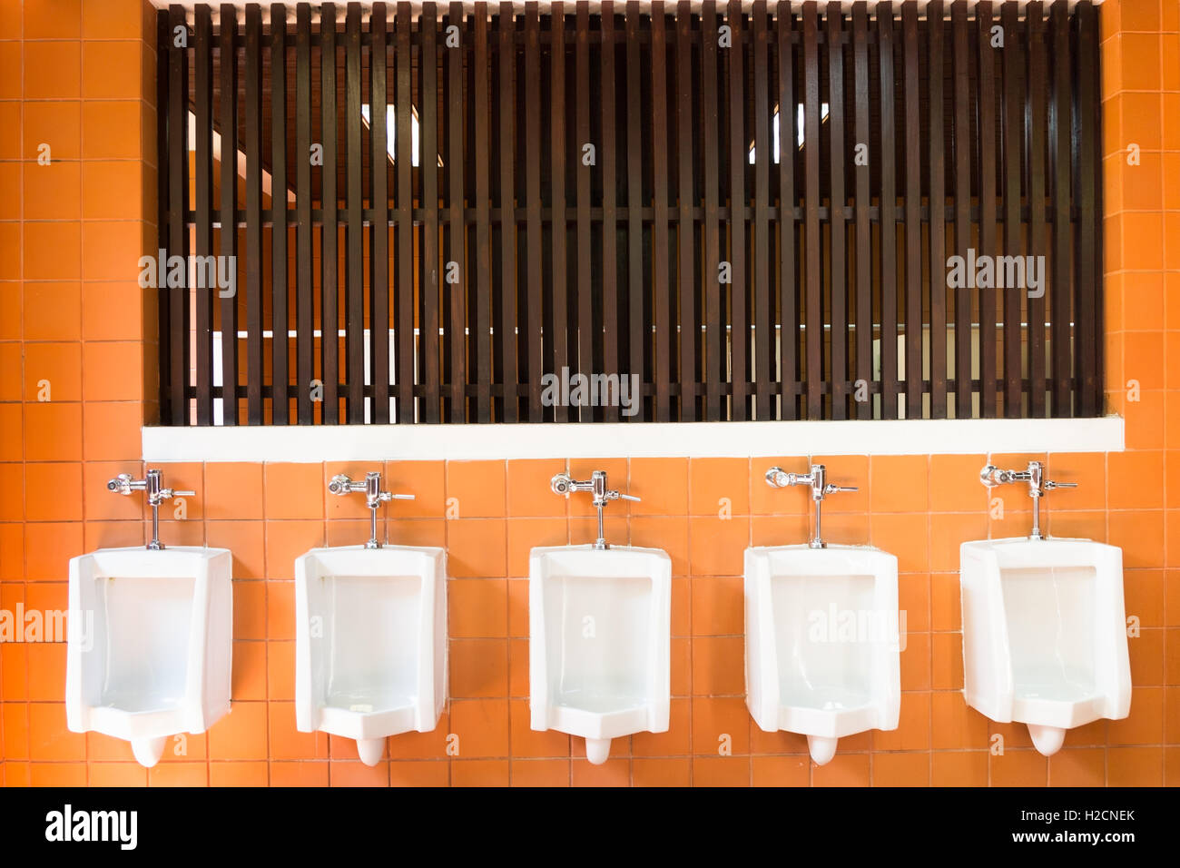 urinals in public men toilet Stock Photo