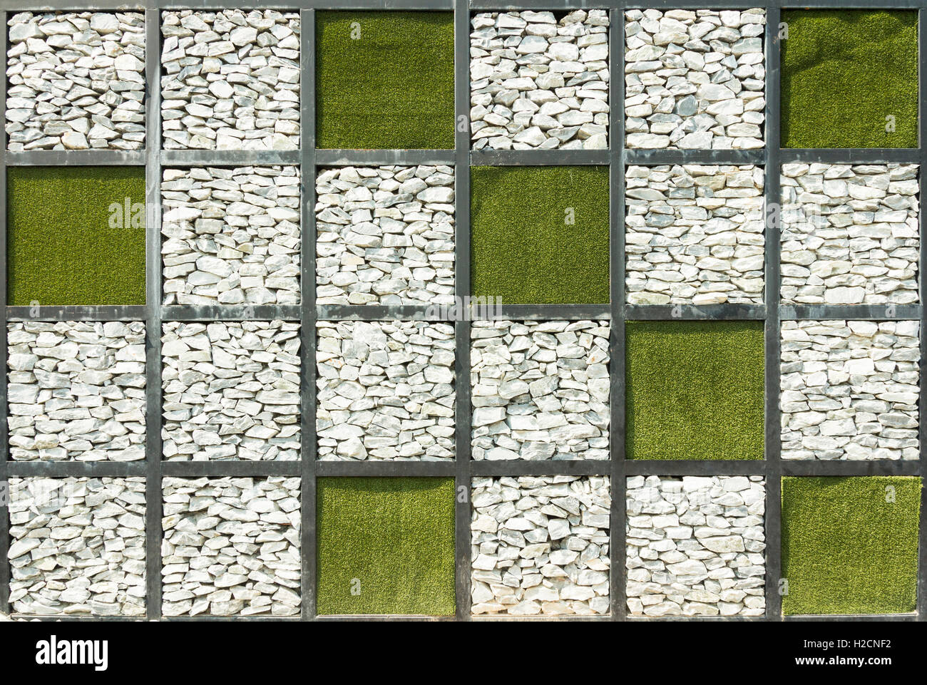 stone wall and green grass background Stock Photo - Alamy