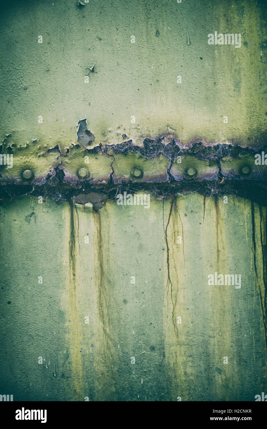 Peeling paint rust and rivets texture. Old metal garage door. Vintage
