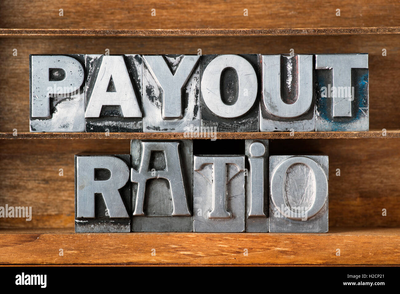 payout ratio phrase made from metallic letterpress type on wooden tray Stock Photo
