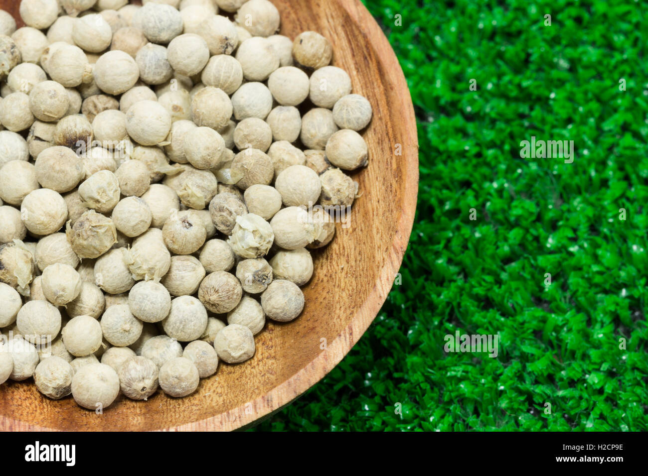 close up white pepper in wooden cup Stock Photo