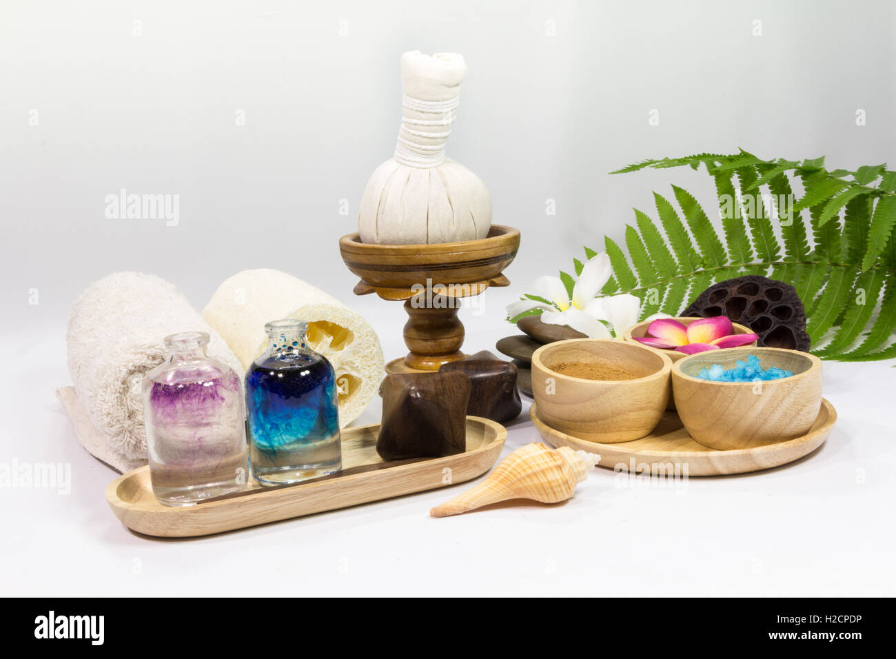 Spa massage setting with towels compress balls and herb Stock Photo Alamy