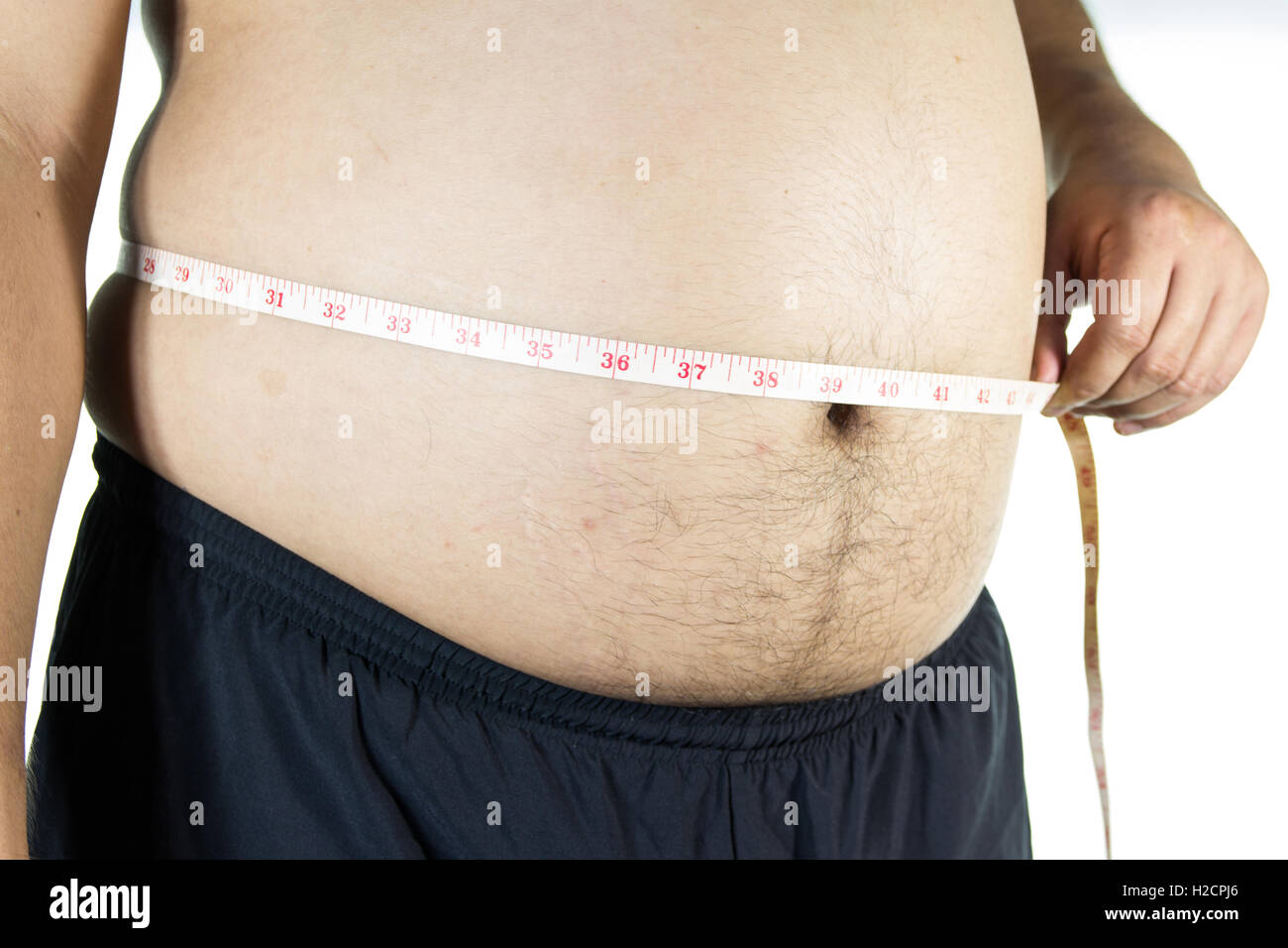 Fat man holding a measuring tape Stock Photo