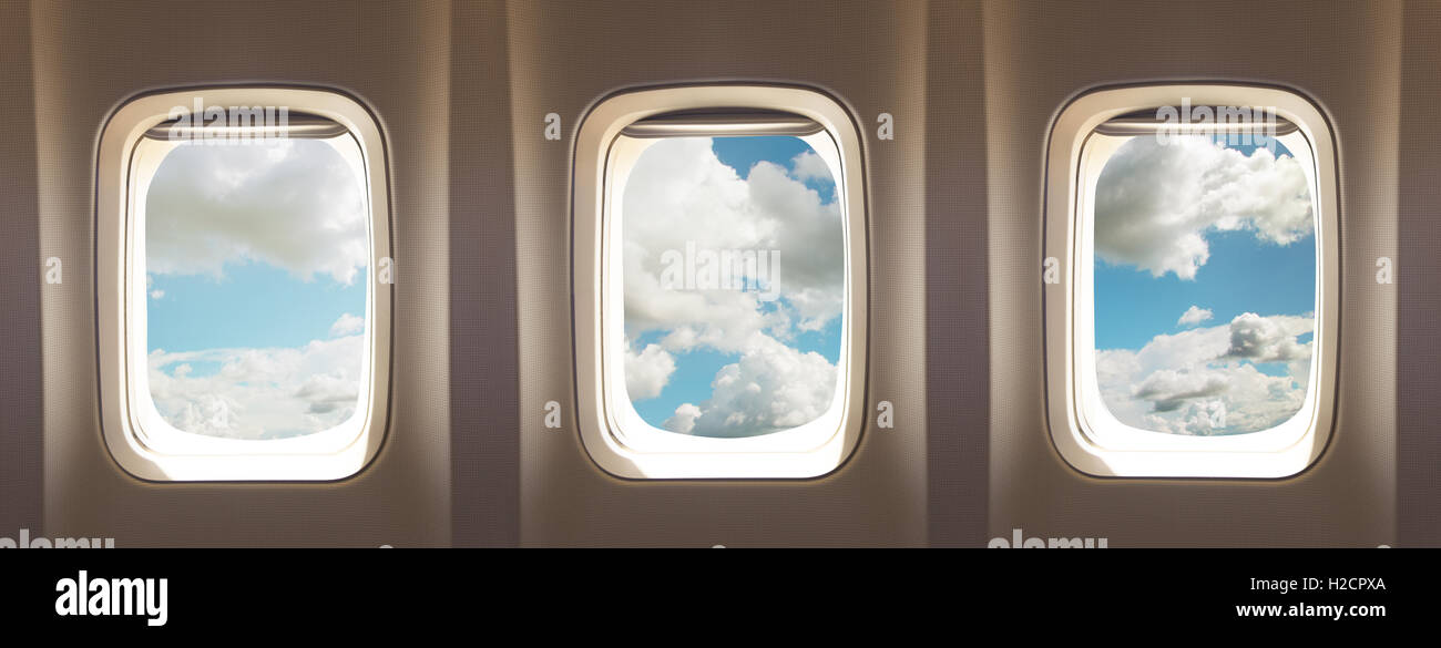 three airplane windows with clouds Stock Photo