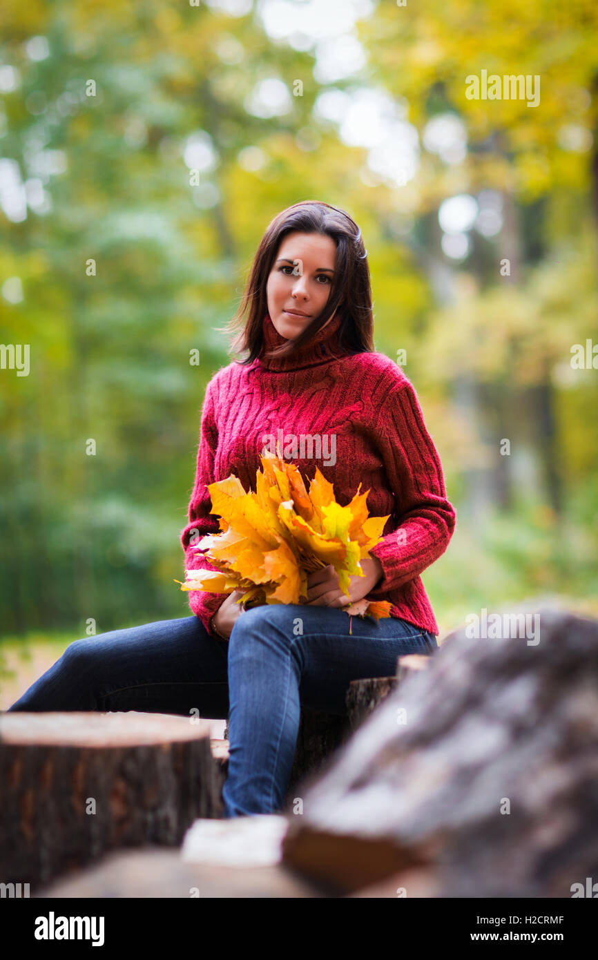 Pretty young woman in a colorful autumn park Stock Photo - Alamy