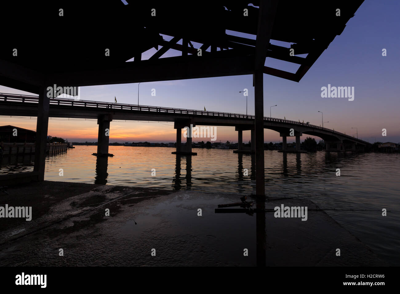 sunset in the sea silhouette bridge and pier Stock Photo - Alamy